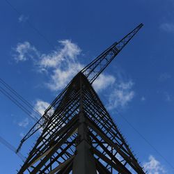 Low angle view of crane against blue sky