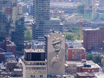 Aerial view of statue amidst buildings in city
