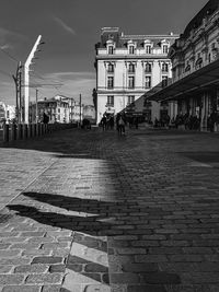 People on street amidst buildings in city