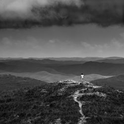 Man standing on mountain road