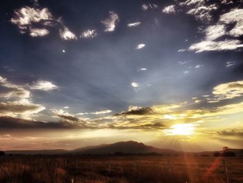 Scenic view of landscape against dramatic sky