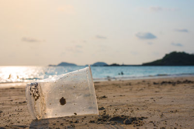 Close-up of sand on beach against sky