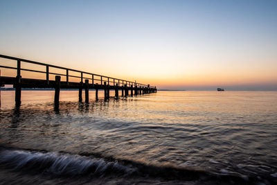 Scenic view of sea against clear sky during sunset