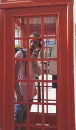 Man talking in telephone booth