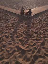 High angle view of people sitting at beach