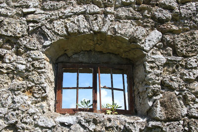 Low angle view of window in old building