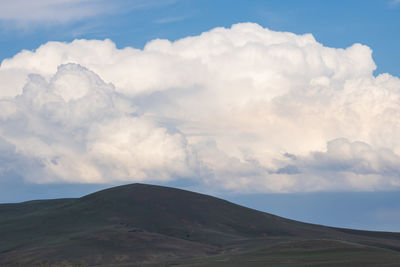 View of volcanic landscape against cloudy sky