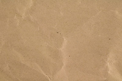 High angle view of paper on sand