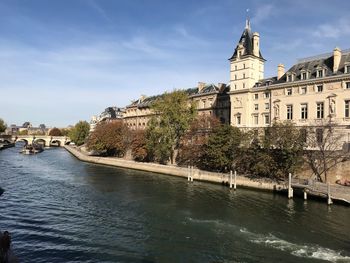 River amidst buildings against sky