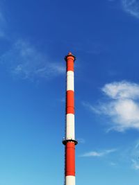 Industrial chimney against the background of blue sky