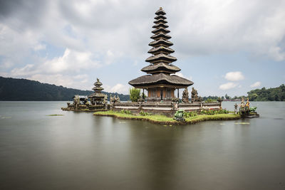 Temple by building against sky