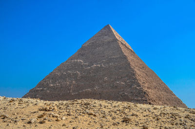 Low angle view of historical building against clear blue sky