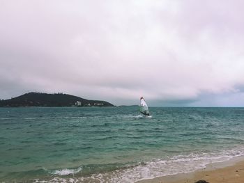 Scenic view of sea against cloudy sky