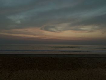 Scenic view of beach against sky during sunset