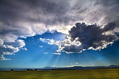 Scenic view of landscape against cloudy sky