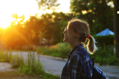 Portrait of young woman looking at sunset