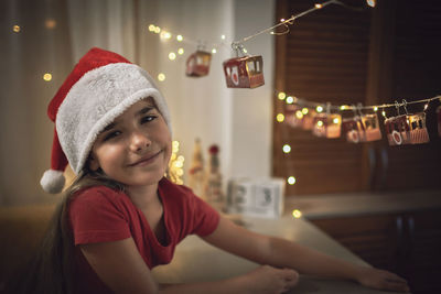 Portrait of smiling girl sitting at home