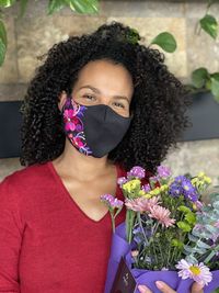 Portrait of beautiful woman with red flower