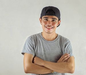 Portrait of a smiling young man against white background