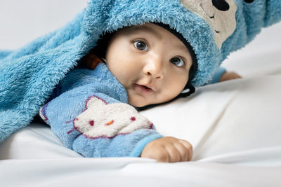 Infant boy lying cute facial expression with white background at indoor