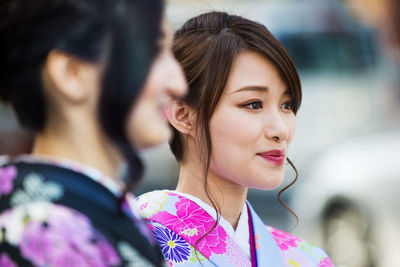 Close-up portrait of a young woman looking away