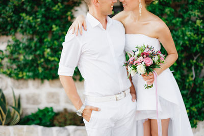 Midsection of woman holding flower bouquet