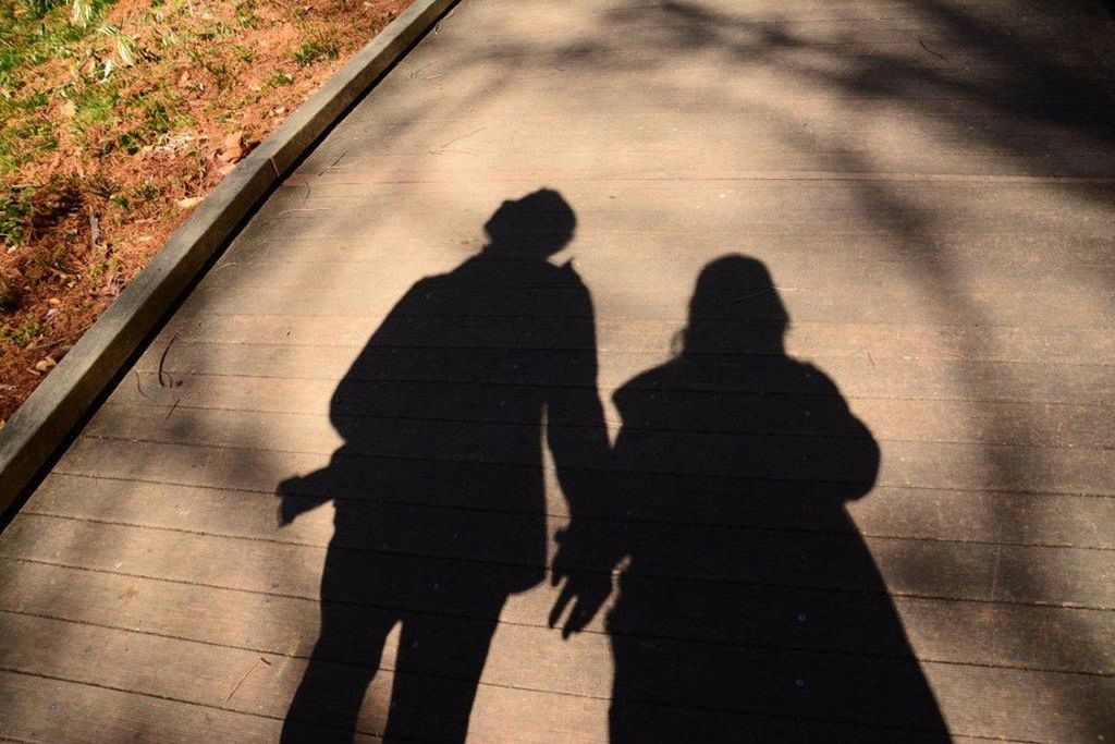 two people, togetherness, walking, shadow, men, couple - relationship, bonding, outdoors, lifestyles, love, sunlight, leisure activity, day, real people, women, adult, adults only, people