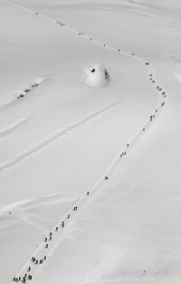 High angle view of people on snow covered field 