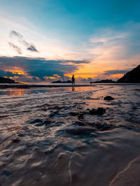 Sunrise reflections on the beach sand.