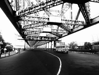 Vehicles on howrah bridge against sky