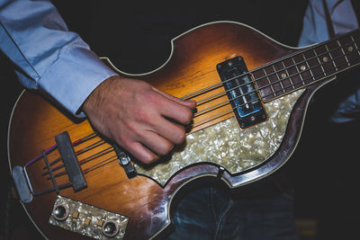 Close-up of man playing guitar