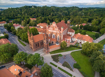 Vilnius old town and st. anne church with hill of three crosses in background. lithuania. sunset