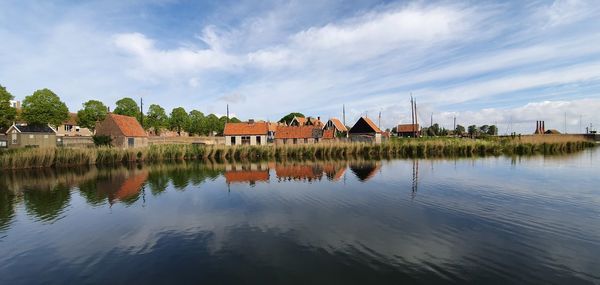 Historic dutch houses by lake in a sunny spring morning