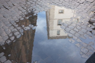 Reflection of building in puddle