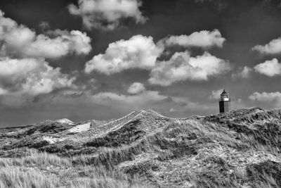 Lighthouse on mountain against sky