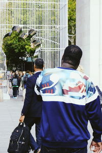 Rear view of people walking on street