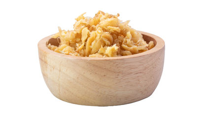 Close-up of bread in bowl against white background