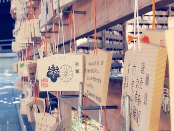 Close-up of text hanging on wood