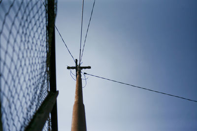 Low angle view of electricity pylon against sky