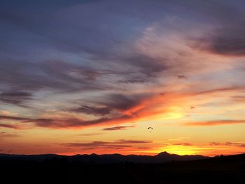 Dramatic sky over silhouette landscape