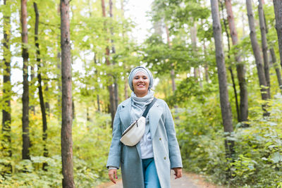 Portrait of a smiling young man in forest