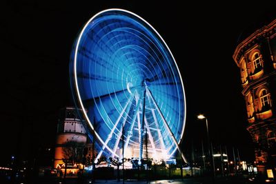 Low angle view of illuminated ferris wheel