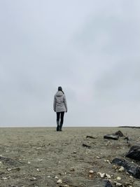 Rear view of woman walking on beach