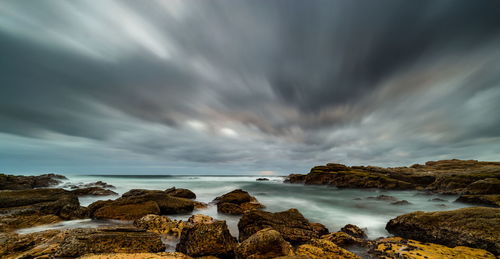 Scenic view of sea against cloudy sky