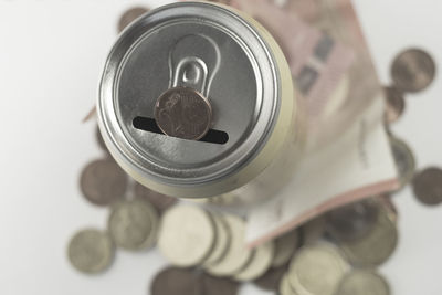 High angle view of currency in tin can