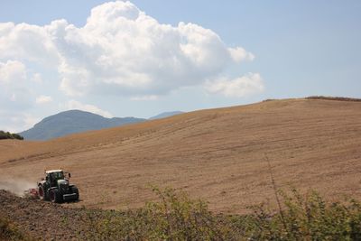 Scenic view of agricultural landscape against sky