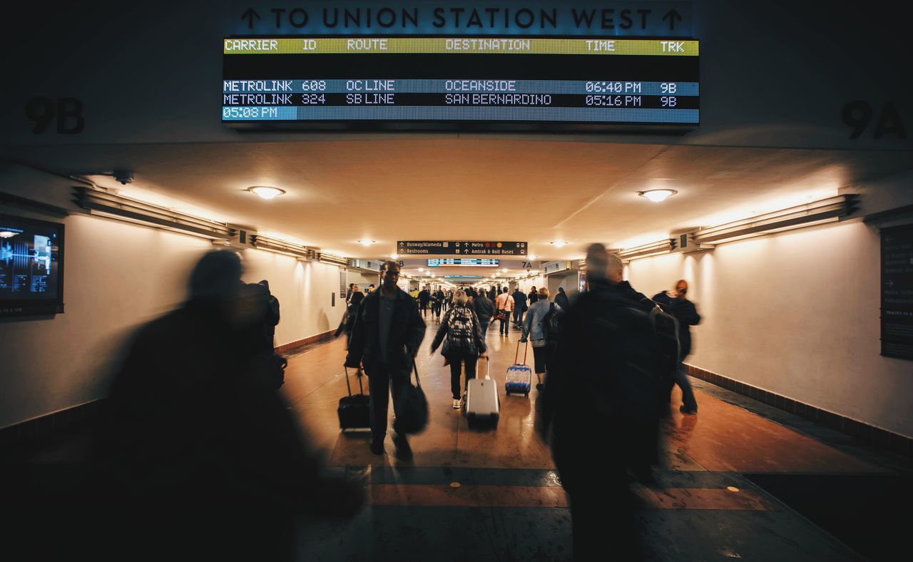 indoors, rear view, illuminated, men, text, airport, people, adults only, adult