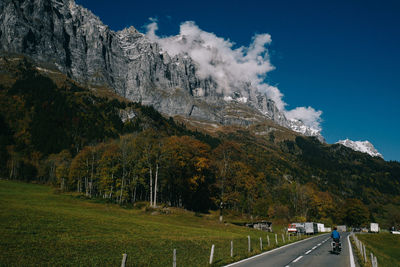 Road amidst trees against sky