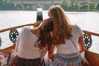 Rear view of women in boat on river