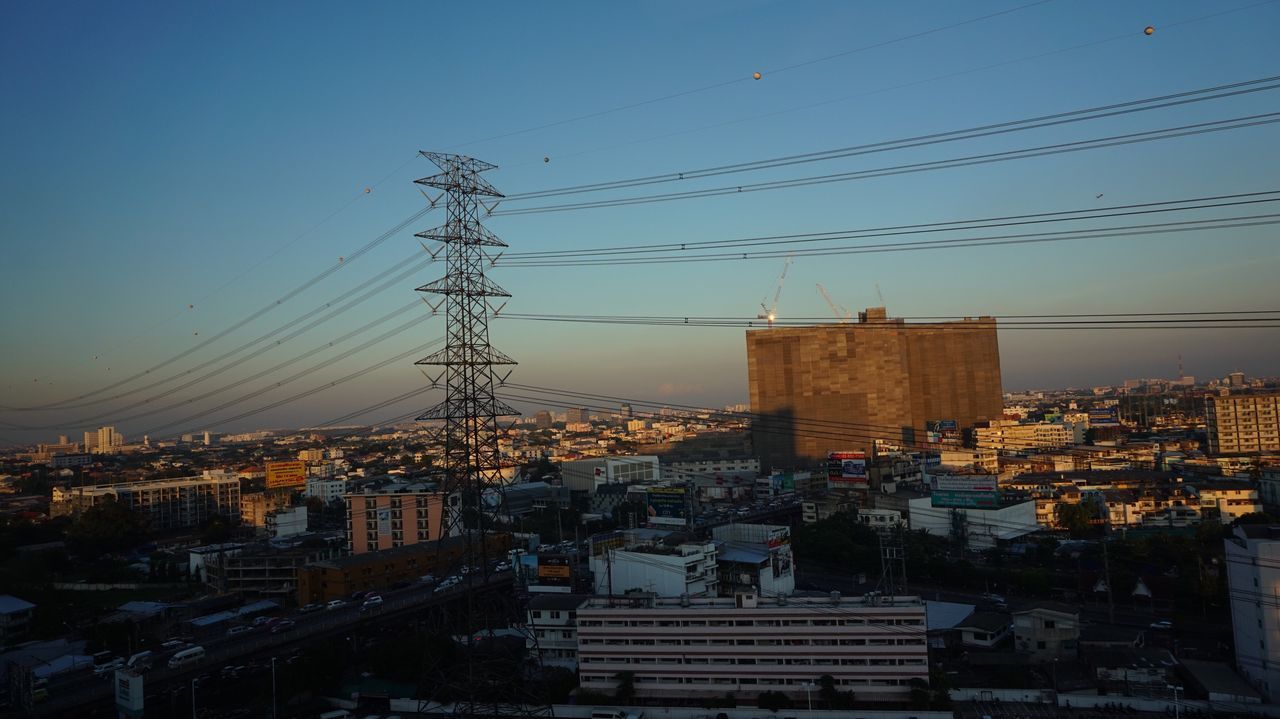 building exterior, architecture, built structure, power supply, power line, electricity pylon, electricity, cable, sky, connection, no people, outdoors, city, technology, residential building, sunset, day